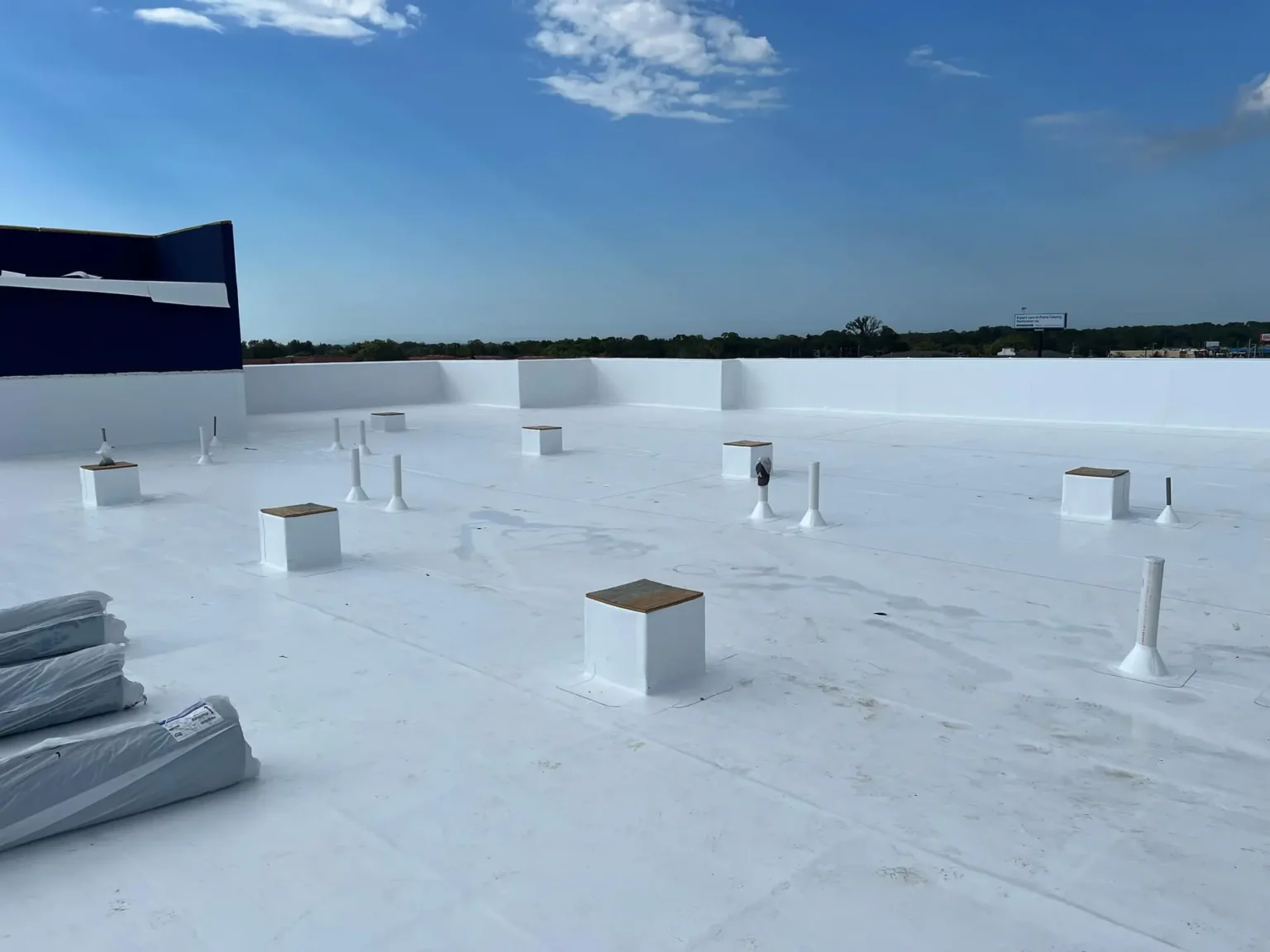 Beautiful blue sky and a view of a commercial flat roof