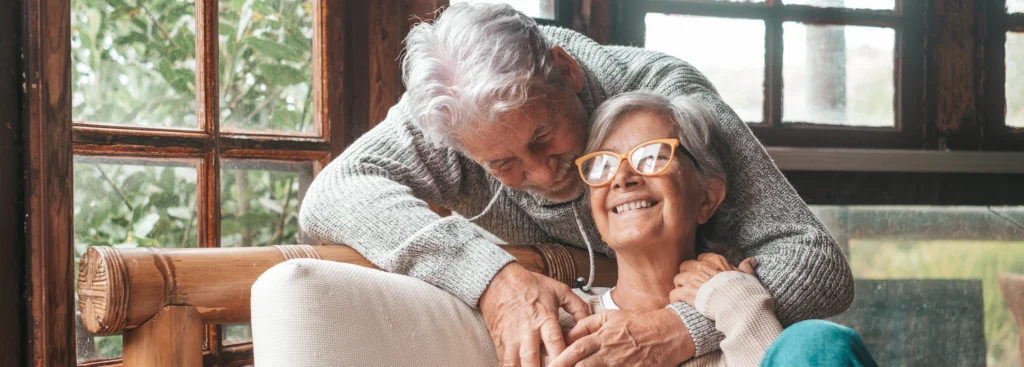 Older couple hugging in house with new roof